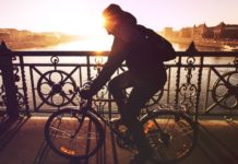 11 Ways To Have A Happy Morning Woman cycling while the sun rises