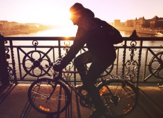 11 Ways To Have A Happy Morning Woman cycling while the sun rises