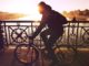 11 Ways To Have A Happy Morning Woman cycling while the sun rises