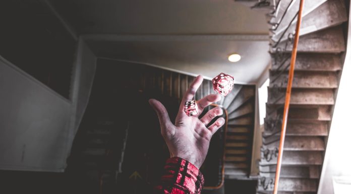 10 Misconceptions About Opportunity A man holding on to two die, signifying opportunity