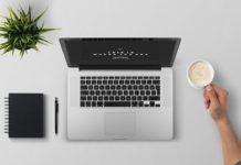 Ways To Stay Motivated While Doing An Online Course Desk with a laptop, notepad and coffee