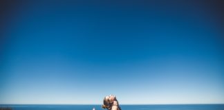 Meditation: A Guide to Mindfulness Woman doing yoga by the sea side