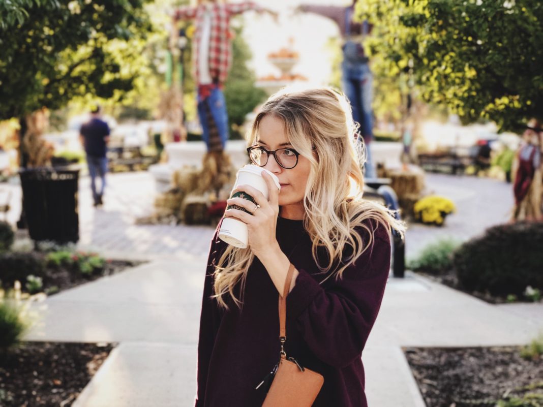 Girl looking confused, while drinking coffee