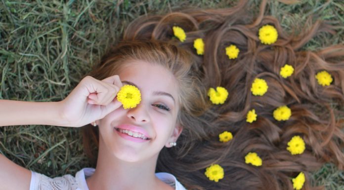 Here’s Why Happiness Absolutely Deserves You Happy girl lying on grass